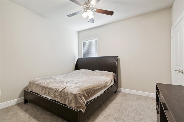 bedroom with light colored carpet and ceiling fan