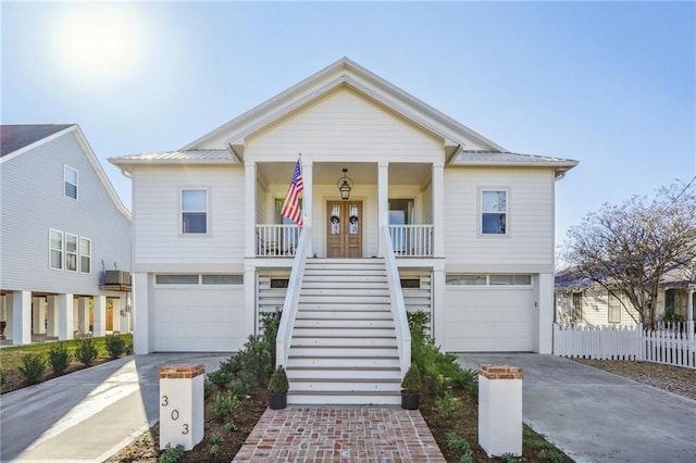 view of front facade with central AC unit, a garage, french doors, and a porch