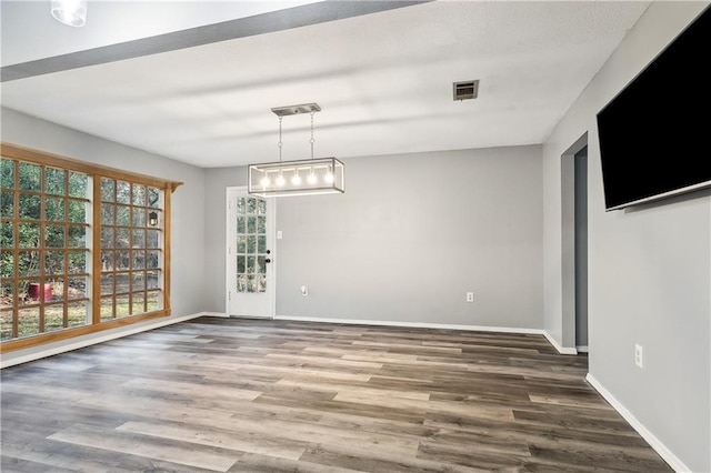 unfurnished dining area with dark wood-type flooring