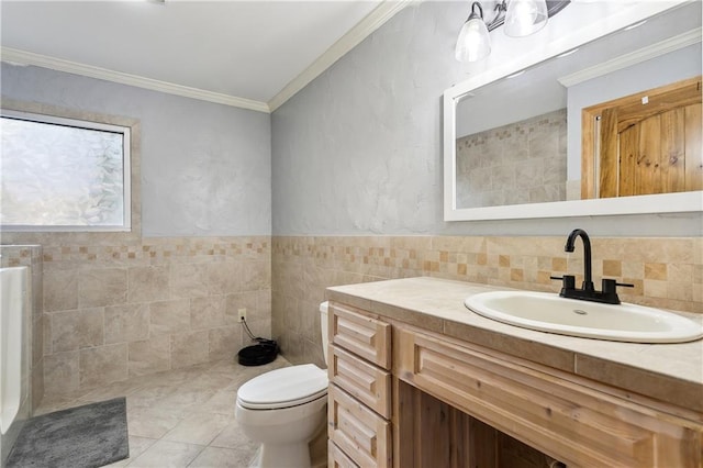 bathroom with tile walls, ornamental molding, vanity, toilet, and tile patterned floors