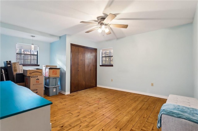 office space with ceiling fan, wood-type flooring, and a wealth of natural light