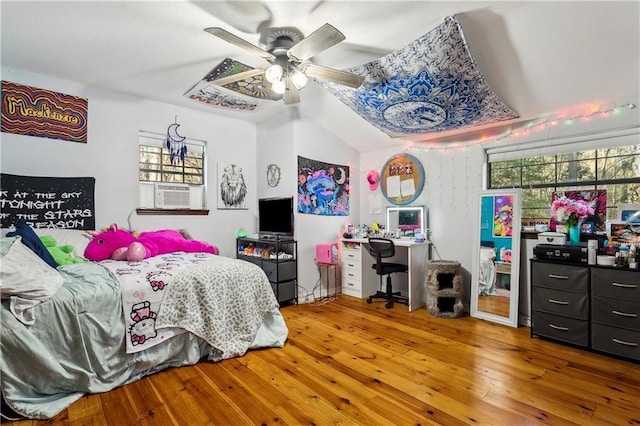 bedroom with vaulted ceiling, ceiling fan, hardwood / wood-style floors, and cooling unit