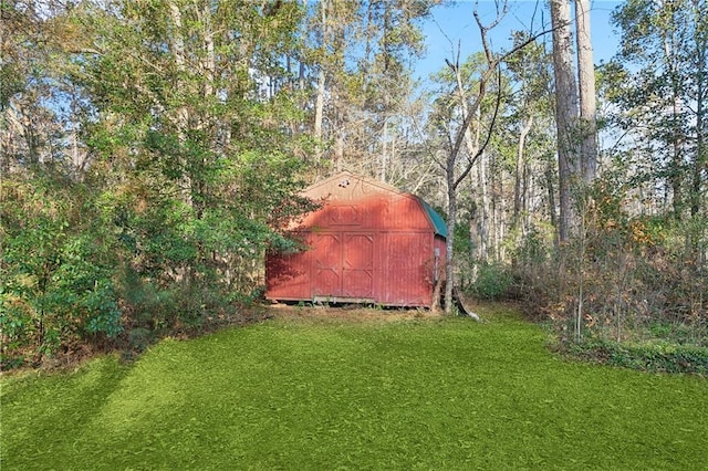 view of outbuilding featuring a yard