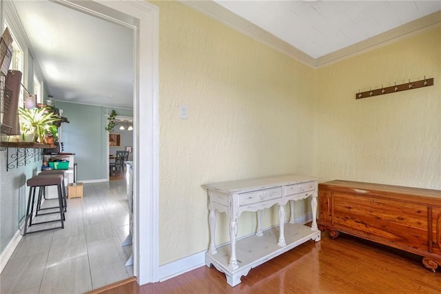 hall with crown molding and hardwood / wood-style flooring