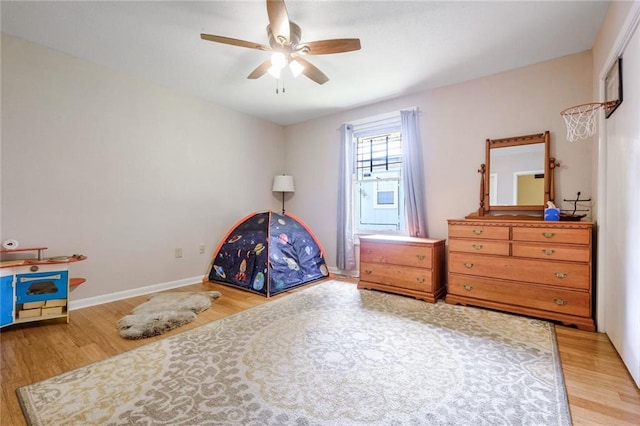 bedroom with wood-type flooring and ceiling fan