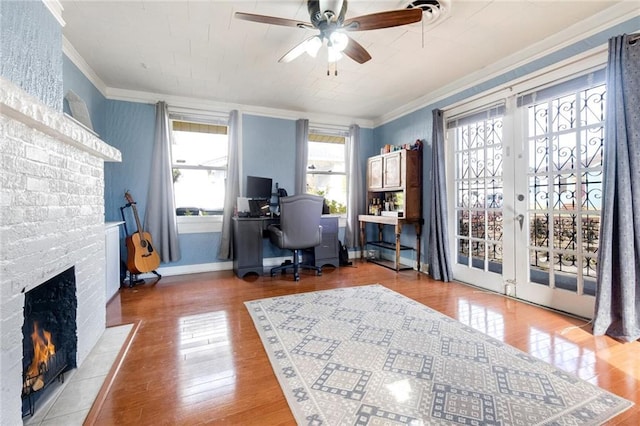 office area with ornamental molding, hardwood / wood-style floors, a fireplace, and french doors