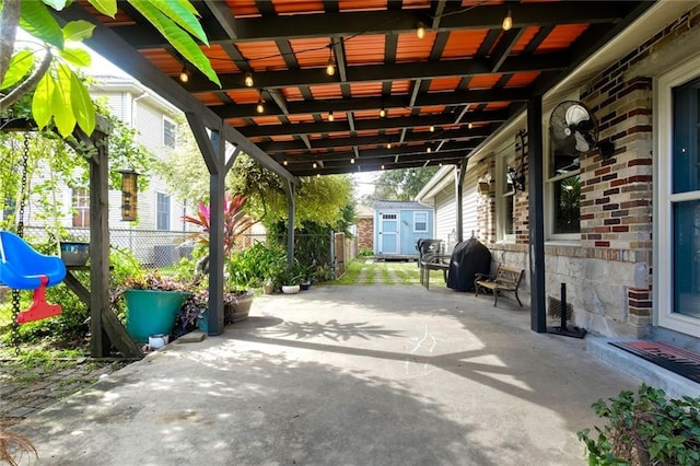 view of patio / terrace with grilling area and a storage shed