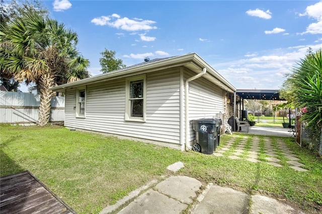 view of side of home with a yard