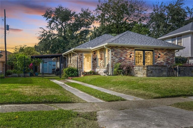 view of front facade featuring a lawn and a carport