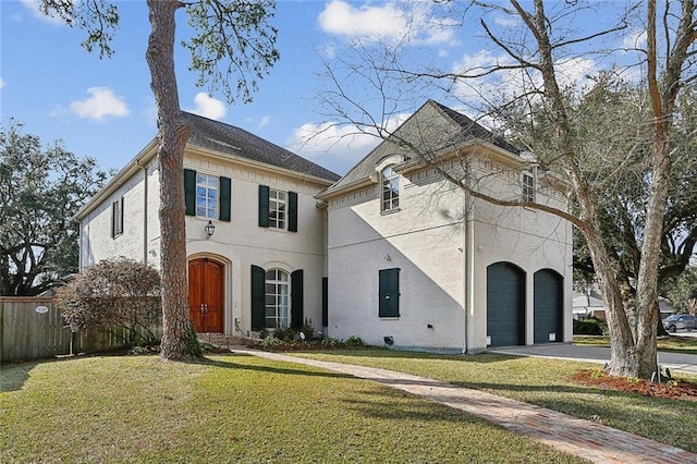 view of front of property with a garage and a front yard