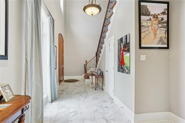 7 Bluebird St, New Orleans, LA 70124 - entrance foyer featuring stairway, marble look tile flooring, and a high ceiling