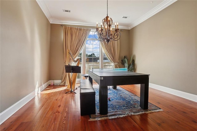 interior space with crown molding, a notable chandelier, and hardwood / wood-style flooring