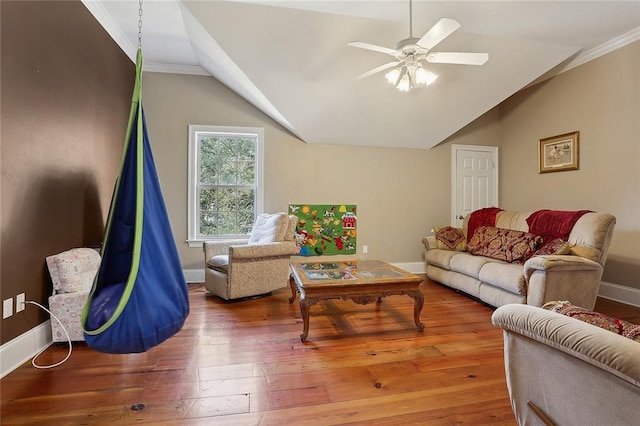 living room with hardwood / wood-style flooring, vaulted ceiling, ornamental molding, and ceiling fan