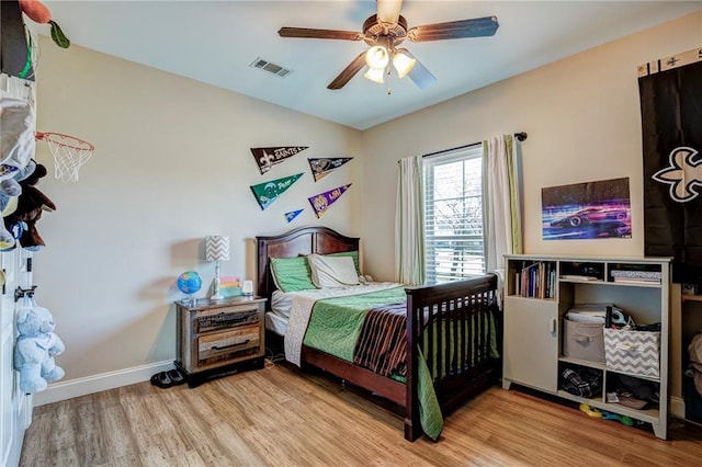 bedroom featuring ceiling fan, lofted ceiling, and light hardwood / wood-style flooring