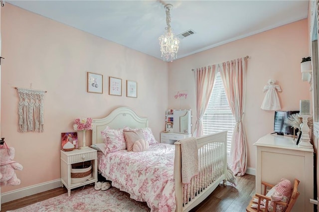 bedroom with an inviting chandelier and wood-type flooring