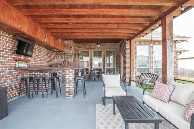 view of patio / terrace featuring outdoor lounge area, ceiling fan, and exterior bar