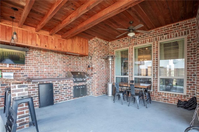 view of patio / terrace with ceiling fan, an outdoor kitchen, and a grill