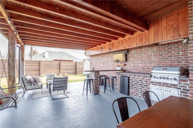 view of patio / terrace with area for grilling, an outdoor bar, and grilling area