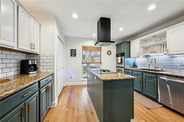 kitchen with sink, stainless steel appliances, a center island, island range hood, and white cabinets