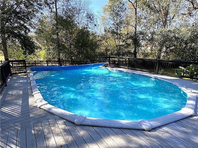 view of swimming pool featuring a deck