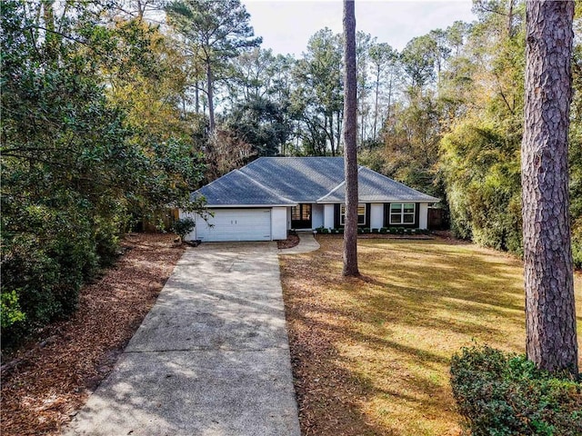 ranch-style home with a garage and a front yard