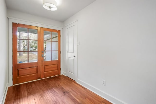 entryway featuring wood-type flooring and french doors