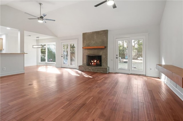 unfurnished living room with ceiling fan, a healthy amount of sunlight, and a fireplace