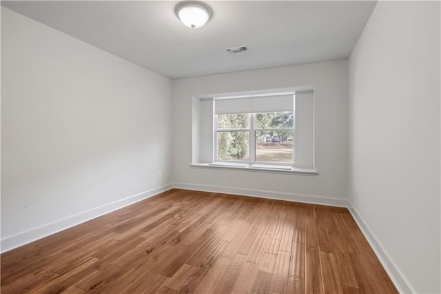 spare room with wood-type flooring