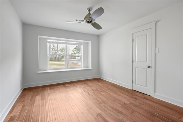 spare room with ceiling fan and light wood-type flooring