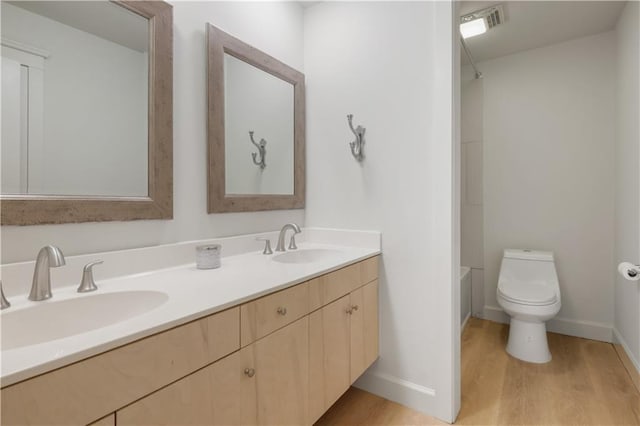 bathroom featuring hardwood / wood-style flooring, vanity, and toilet