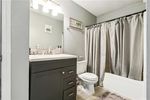 full bathroom featuring shower / bath combo, hardwood / wood-style floors, vanity, a textured ceiling, and toilet