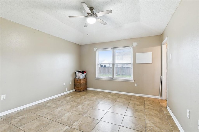 unfurnished room with light tile patterned flooring, ceiling fan, and a textured ceiling