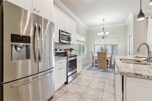 kitchen featuring white cabinetry, sink, pendant lighting, and appliances with stainless steel finishes