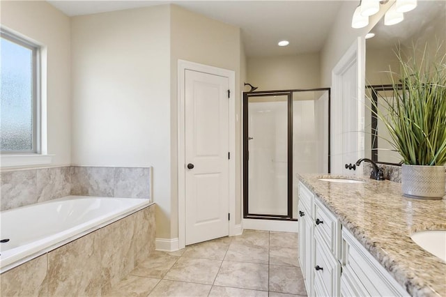 bathroom featuring shower with separate bathtub, vanity, and tile patterned floors