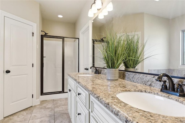 bathroom with vanity, tile patterned floors, and a shower with shower door