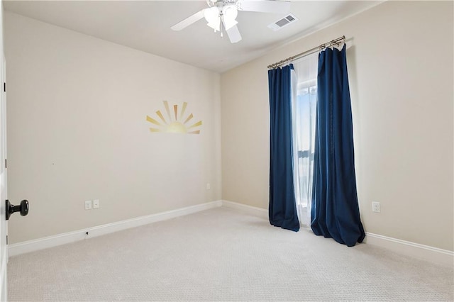 unfurnished room with ceiling fan and light carpet