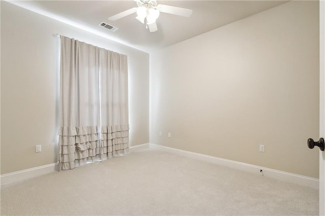 carpeted spare room with ceiling fan