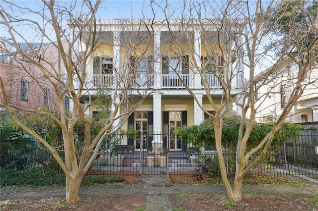 view of front of house featuring a balcony