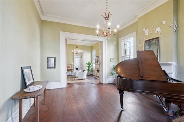 sitting room featuring an inviting chandelier, crown molding, and dark hardwood / wood-style floors