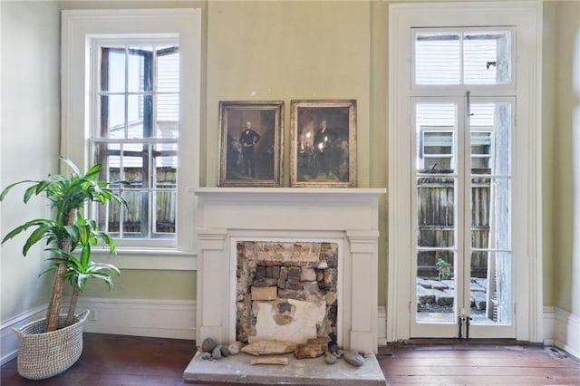 interior details featuring a fireplace and wood-type flooring