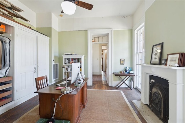 home office featuring ceiling fan and dark hardwood / wood-style flooring