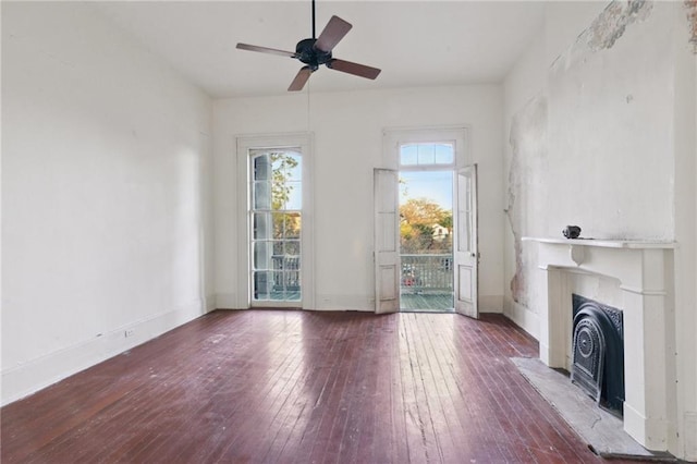 unfurnished living room with hardwood / wood-style floors and ceiling fan