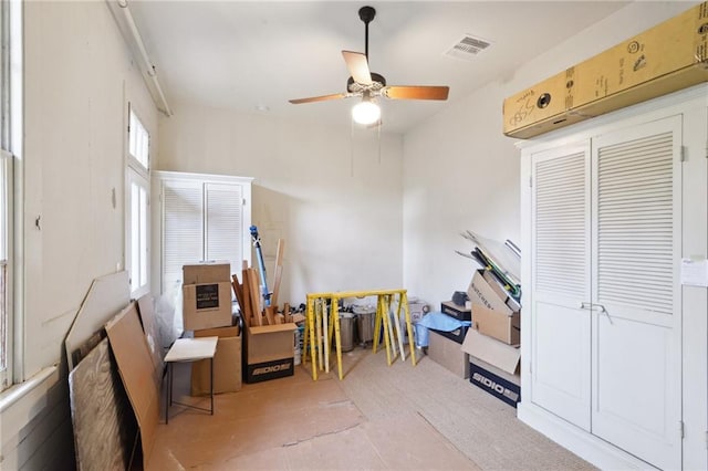 interior space with ceiling fan