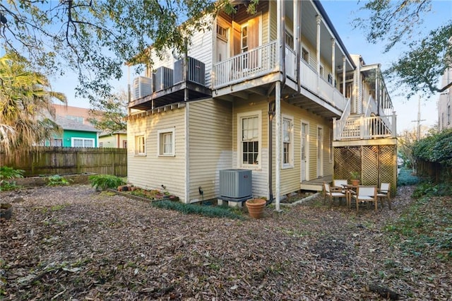 back of house with central AC unit