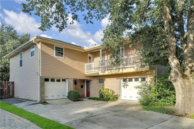 view of front of home featuring a garage and a balcony