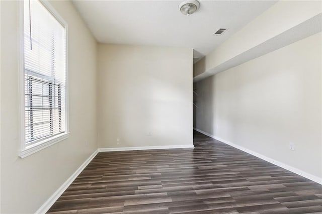 unfurnished room with dark hardwood / wood-style flooring