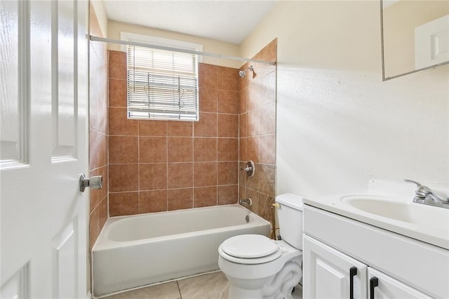 full bathroom featuring tile patterned floors, vanity, toilet, and tiled shower / bath combo