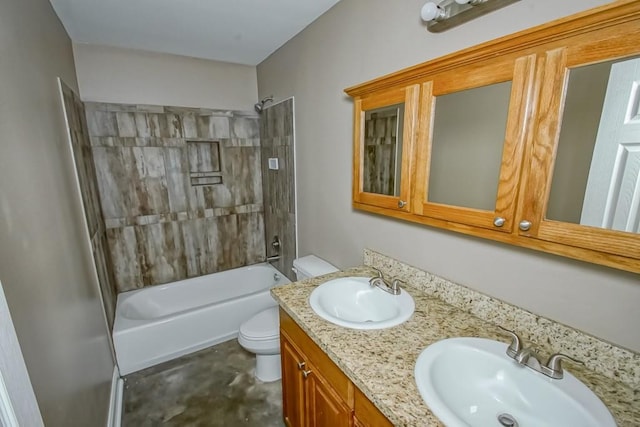 full bathroom featuring vanity, tiled shower / bath, and toilet