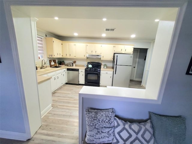 kitchen with sink, white cabinetry, dishwasher, white fridge, and black gas range