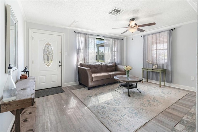 9028 Camille Ave, River Ridge, LA 70123 - entryway with visible vents, crown molding, ceiling fan, wood finished floors, and a textured ceiling
